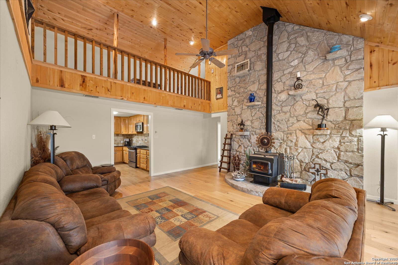 127 Camp Alzafar Road Boerne, TX 78006 - Photo 10 of 50 a living room with furniture a fireplace and a flat screen tv