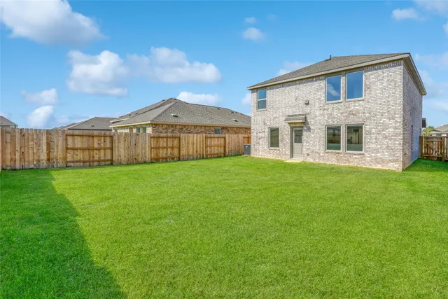 a view of a tennis ground with a table and chairs