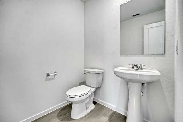 a bathroom with a sink toilet and a mirror