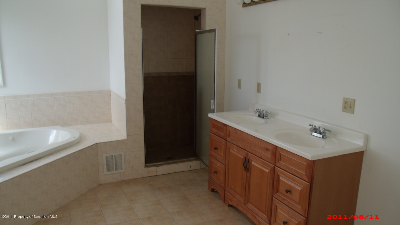 2 Pitcavage Moscow, PA 18444 - Photo 12 of 27 a bathroom with a double vanity sink and mirror with bathtub