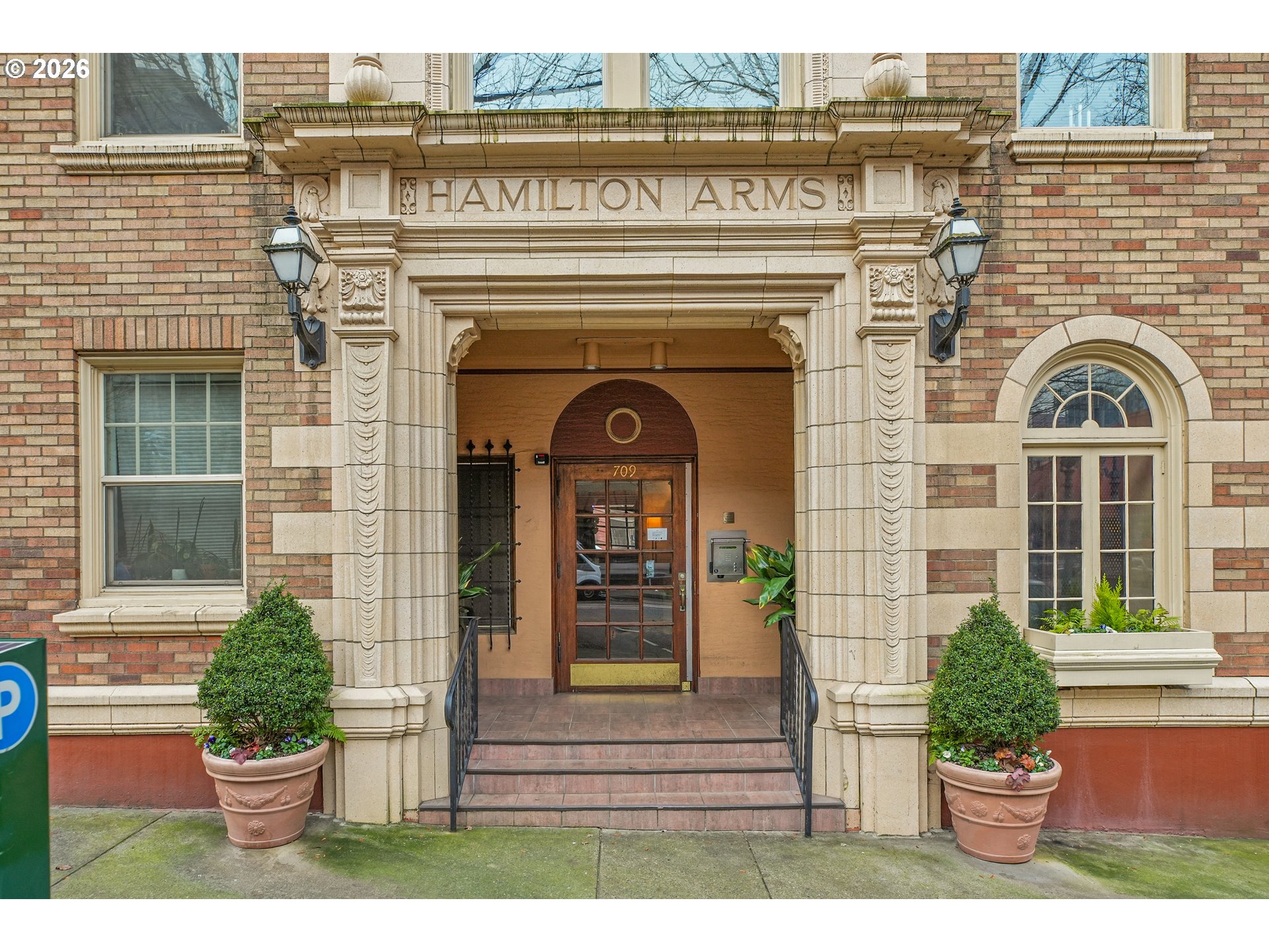 a front view of a house with potted plants