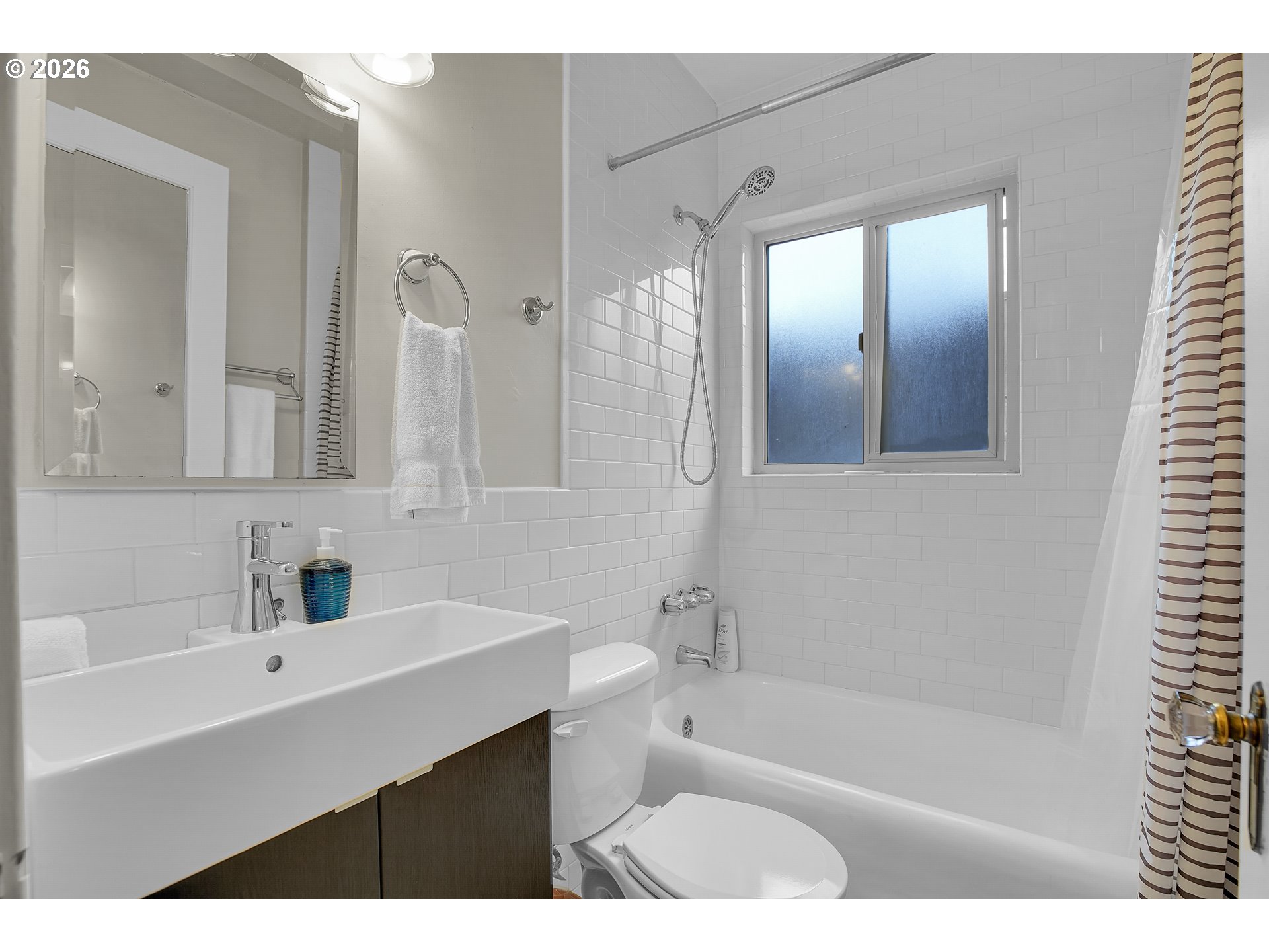 709 Southwest 16th Avenue, Unit 207 Portland, OR 97205 - Photo 12 of 47 a bathroom with a bathtub a sink a mirror and a shower