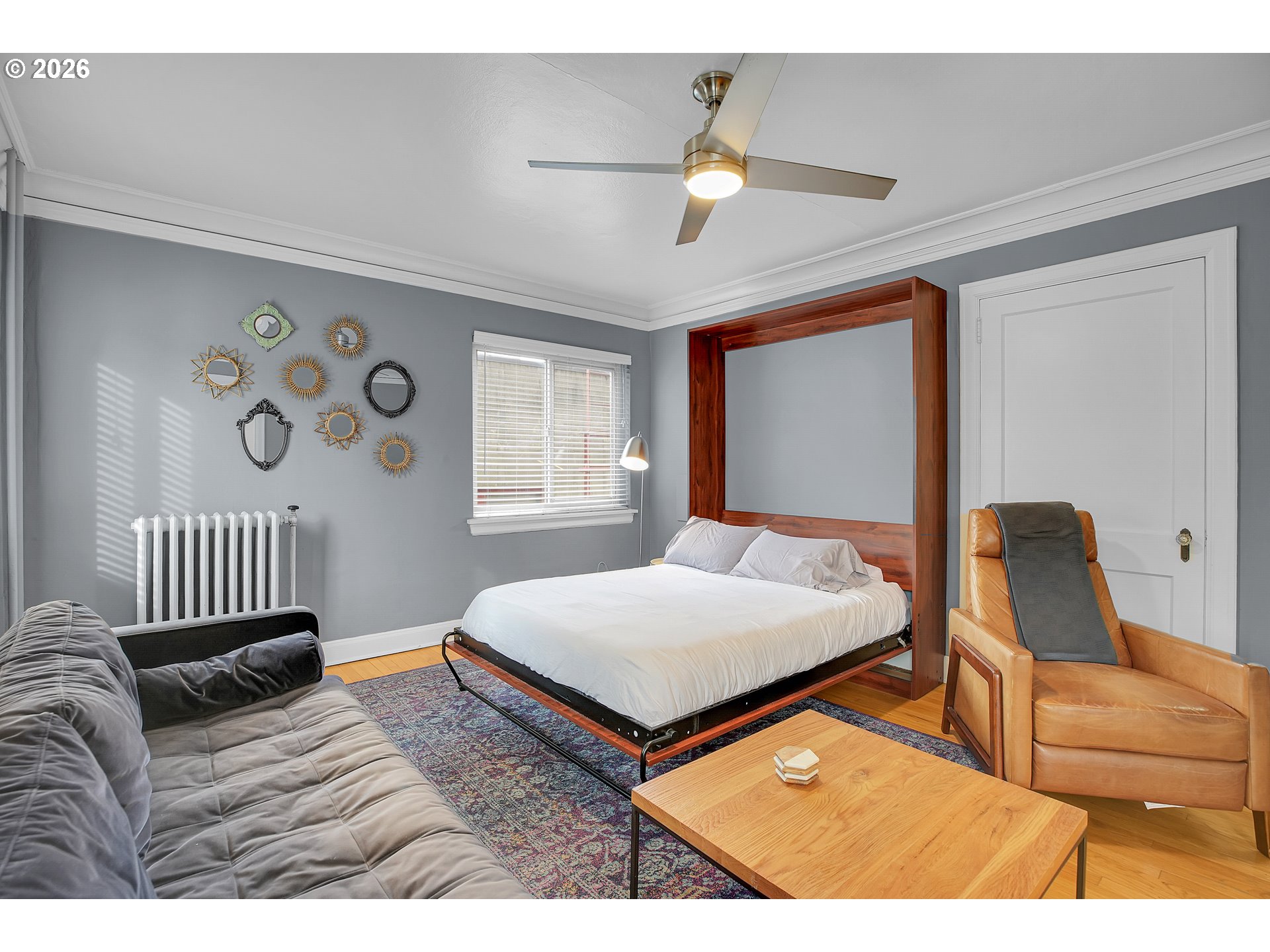 709 Southwest 16th Avenue, Unit 207 Portland, OR 97205 - Photo 17 of 47 a bedroom with a bed and a chandelier