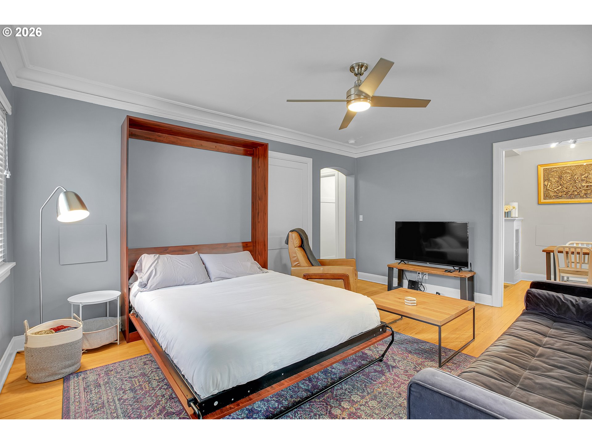 709 Southwest 16th Avenue, Unit 207 Portland, OR 97205 - Photo 18 of 47 a bedroom with a bed and a flat screen tv