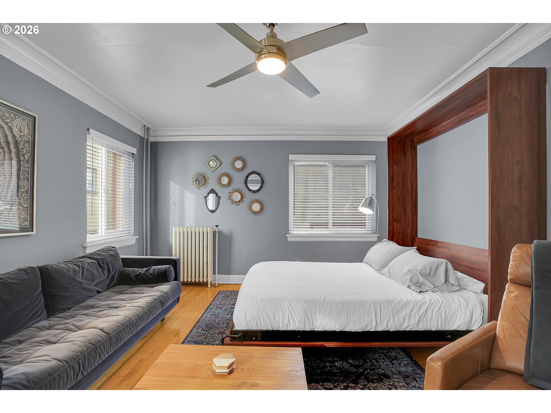 709 Southwest 16th Avenue, Unit 207 Portland, OR 97205 - Photo 19 of 47 a bed sitting in a bedroom next to a window