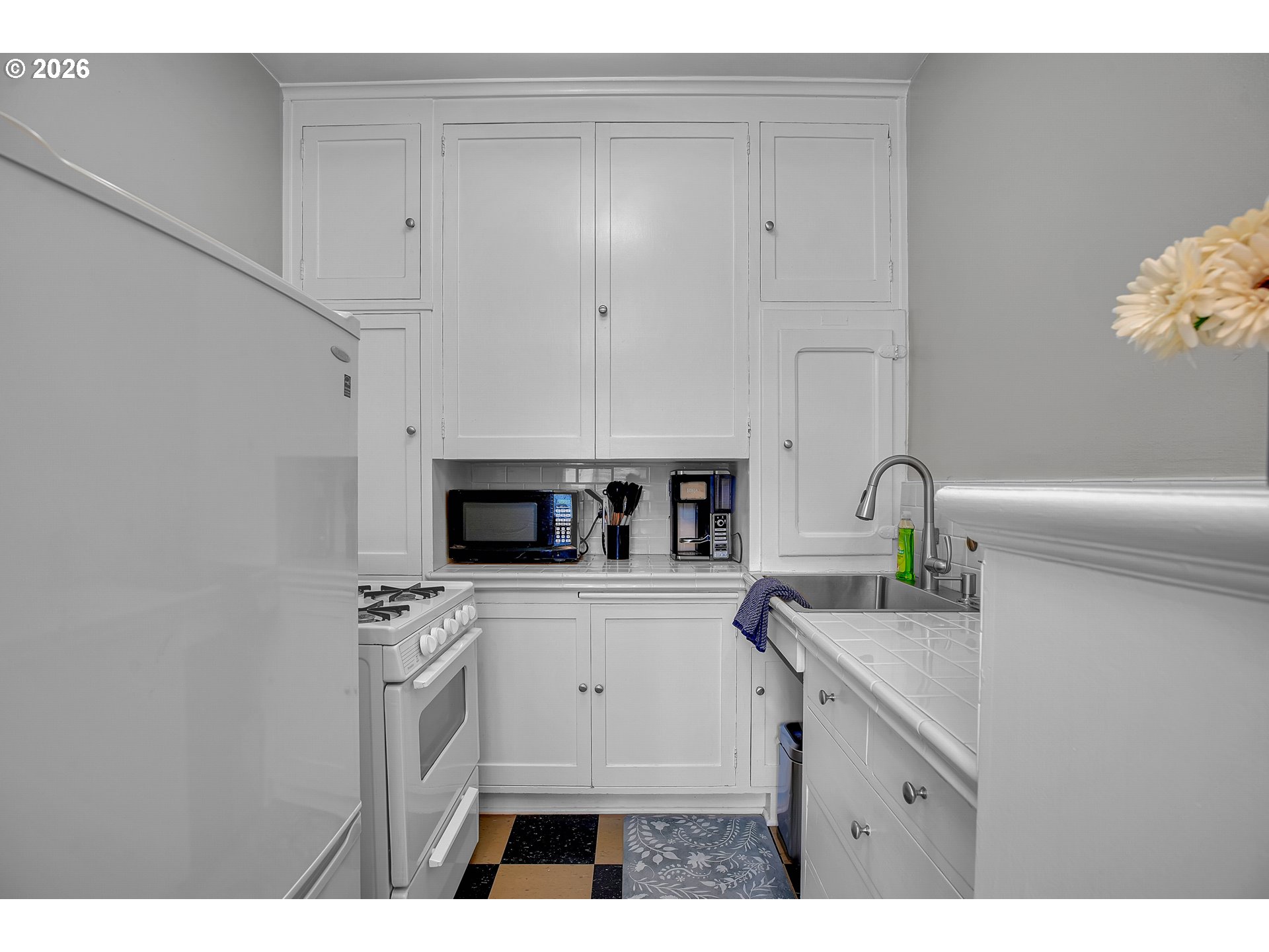709 Southwest 16th Avenue, Unit 207 Portland, OR 97205 - Photo 29 of 47 a kitchen with appliances a sink and cabinets