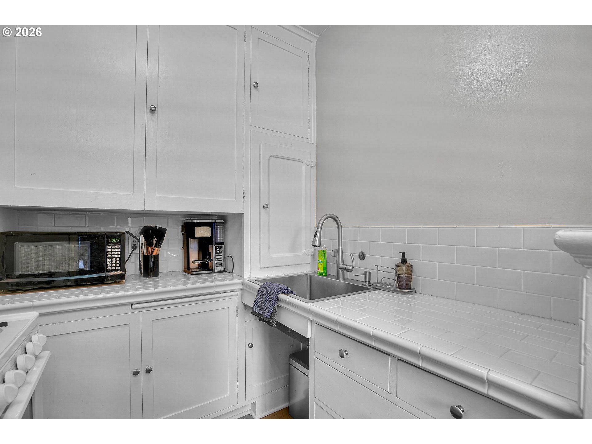 709 Southwest 16th Avenue, Unit 207 Portland, OR 97205 - Photo 30 of 47 a kitchen with a sink and cabinets
