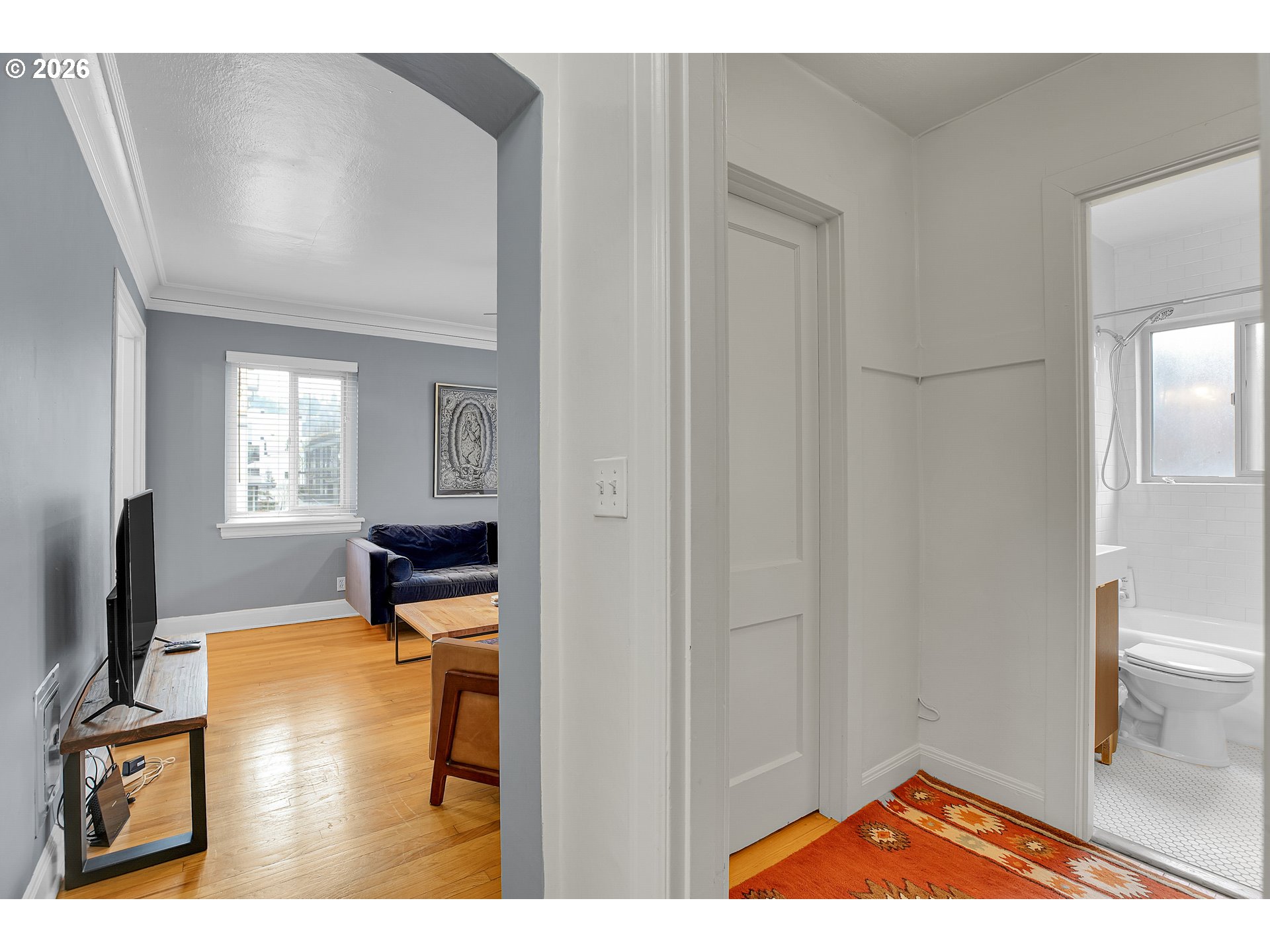 709 Southwest 16th Avenue, Unit 207 Portland, OR 97205 - Photo 10 of 47 a bedroom with a bed and a flat screen tv