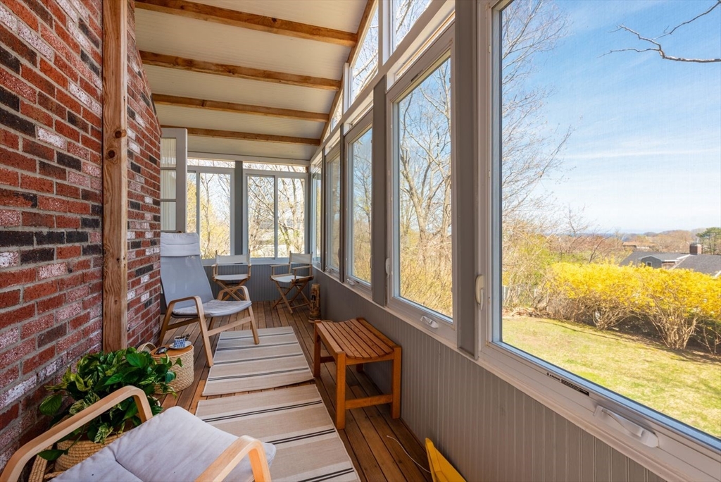 4 Graystone Road Gloucester, MA 01930 - Photo 11 of 34 a view of a balcony with chairs and wooden floor
