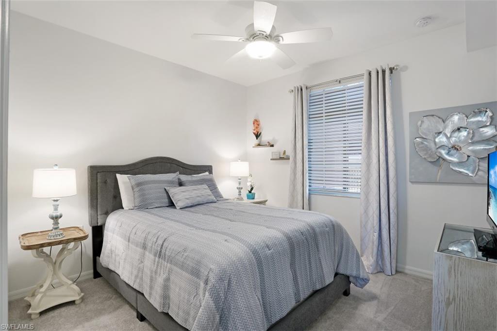 43010 Greenway Boulevard, Unit 234 Punta Gorda, FL 33982 - Photo 13 of 22 a bedroom with a bed and a chandelier