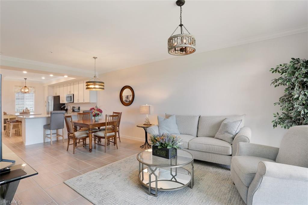 43010 Greenway Boulevard, Unit 234 Punta Gorda, FL 33982 - Photo 3 of 22 a living room with furniture a clock and a chandelier