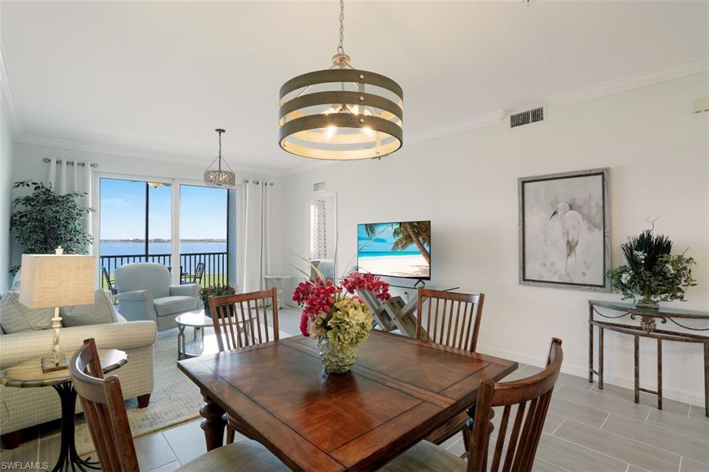 43010 Greenway Boulevard, Unit 234 Punta Gorda, FL 33982 - Photo 10 of 22 a view of a dining room with furniture and wooden floor