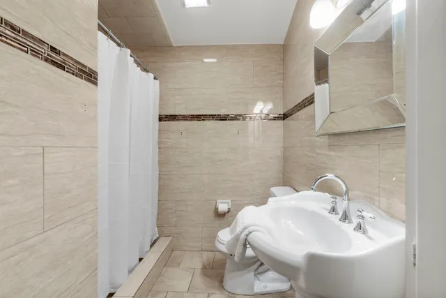 a living room with furniture a chandelier and a window