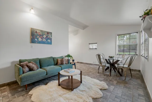 a white house that has a tree in front of it