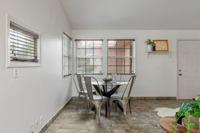 a kitchen with granite countertop a sink a stove and cabinets