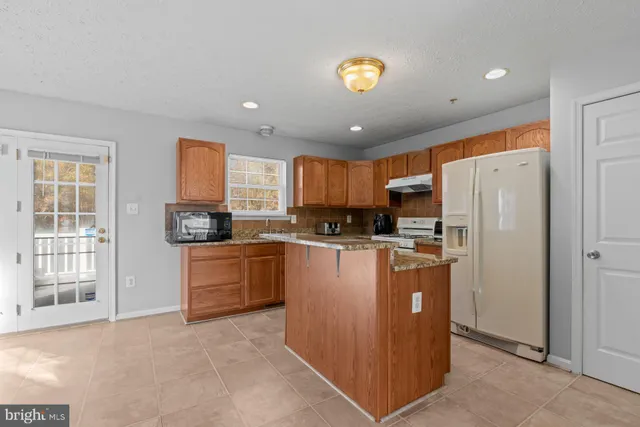 a kitchen with refrigerator cabinets and a counter top space