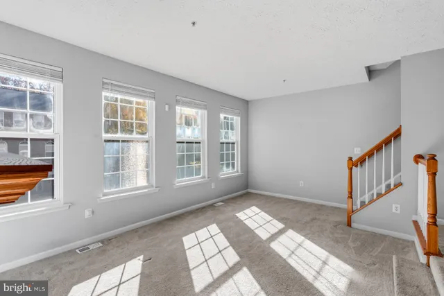 a view of an empty room with windows