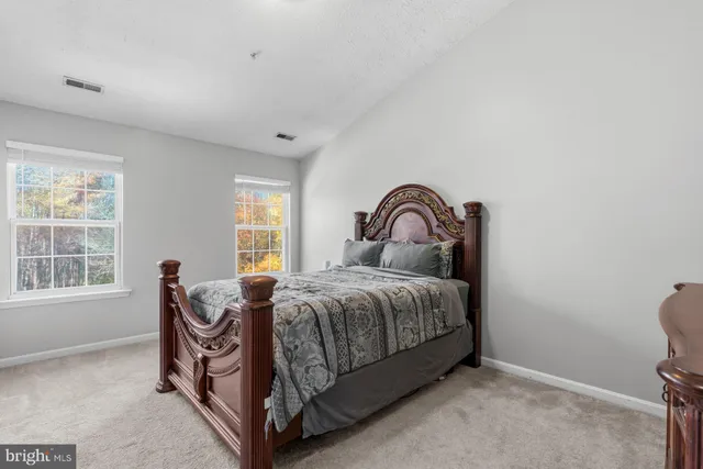 a bed sitting in a room next to a window