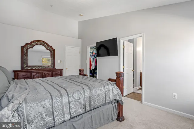 a bedroom with a bed and a large mirror