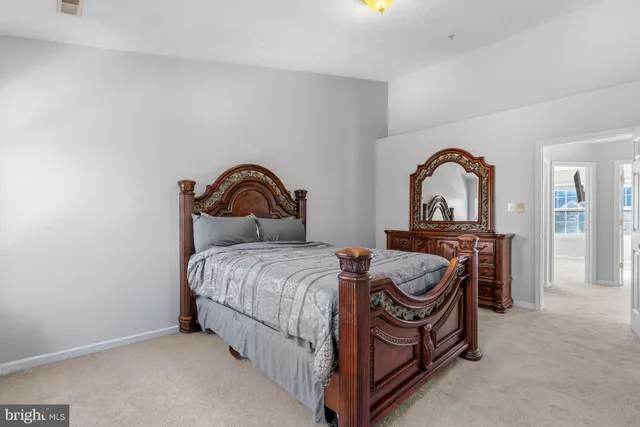 a bedroom with a bed and dresser