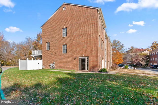 a view of a house with backyard and a tree