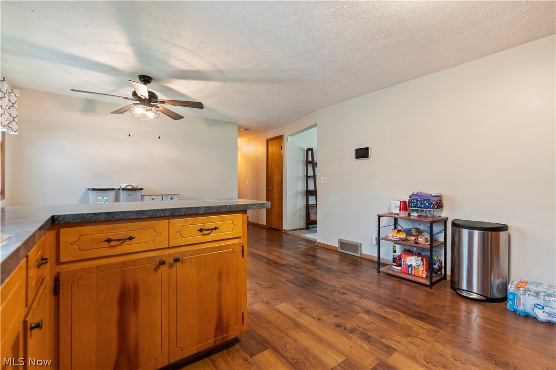 4904 3rd Street Northwest Canton, OH 44708 - Photo 14 of 31 Kitchen with ceiling fan, a textured ceiling, and dark hardwood / wood-style floors
