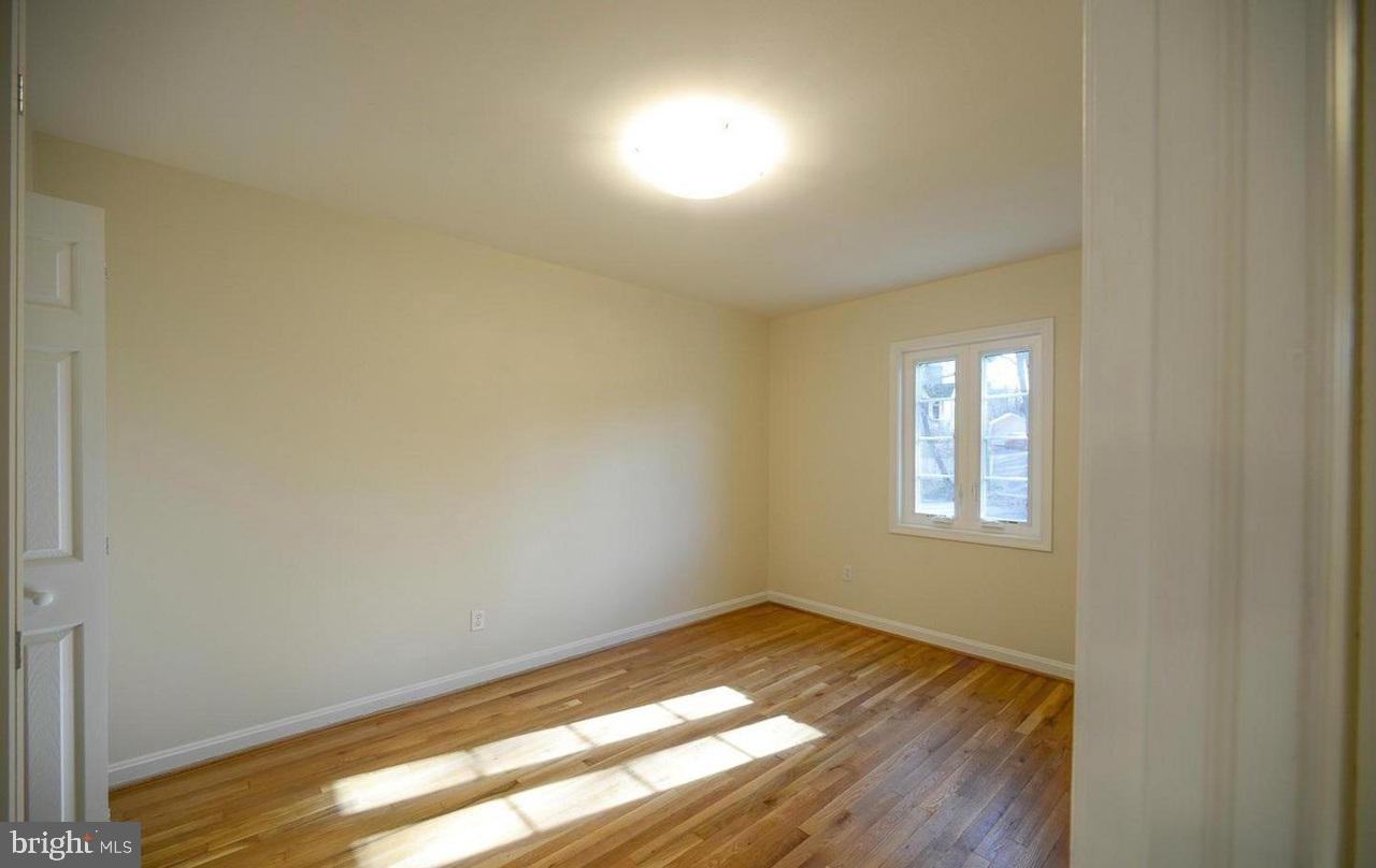 2503 Holman Avenue Silver Spring, MD 20910 - Photo 11 of 15 a view of empty room with wooden floor and fan