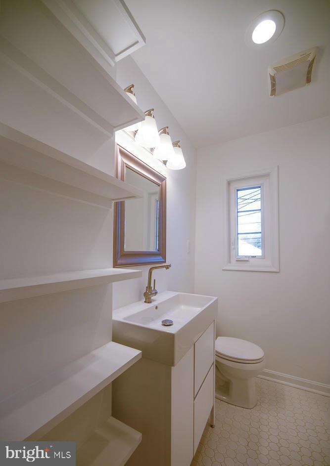2503 Holman Avenue Silver Spring, MD 20910 - Photo 13 of 15 a bathroom with a toilet sink and mirror
