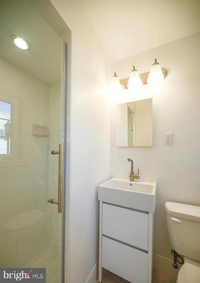 2503 Holman Avenue Silver Spring, MD 20910 - Photo 14 of 15 a bathroom with a toilet sink and mirror