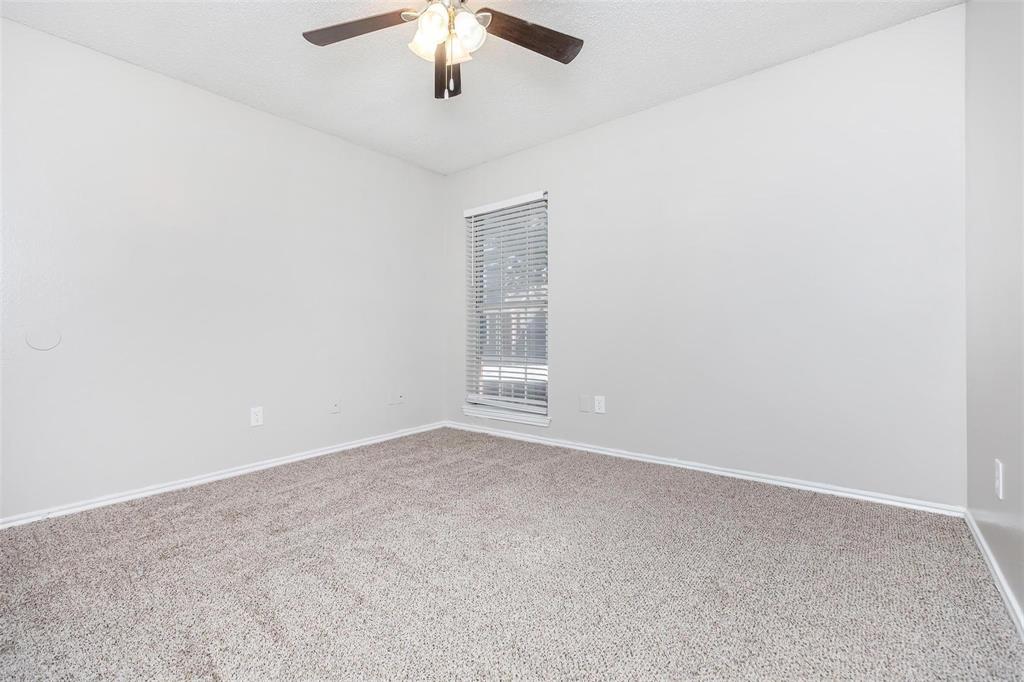 1826 Esters Road, Unit 1050 Irving, TX 75061 - Photo 23 of 39 Ceiling fan with integrated lighting, window with blinds, and neutral-toned carpeting