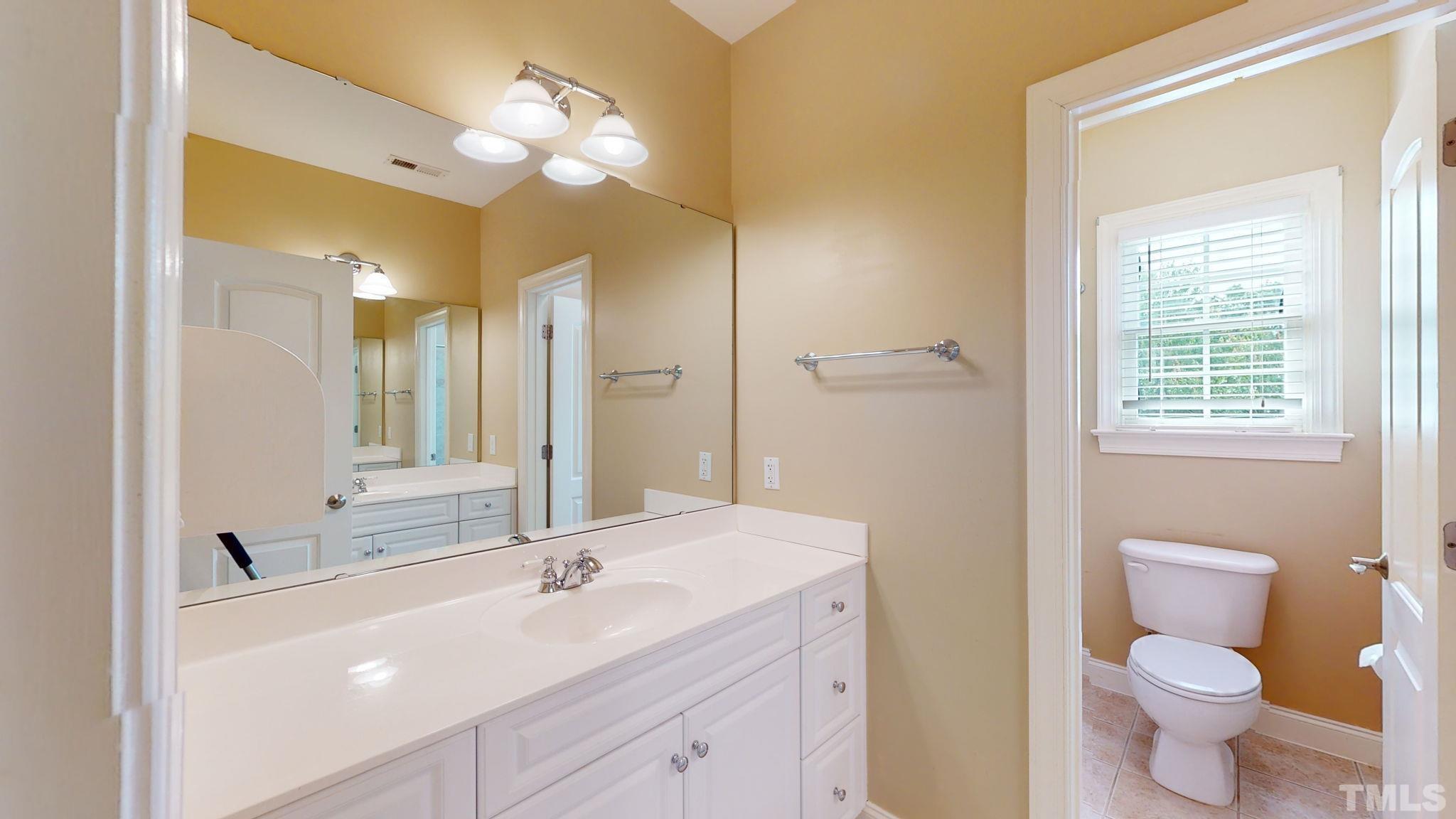 1931 Hornbeck Court Raleigh, NC 27614 - Photo 25 of 31 a bathroom with a sink a toilet and a mirror