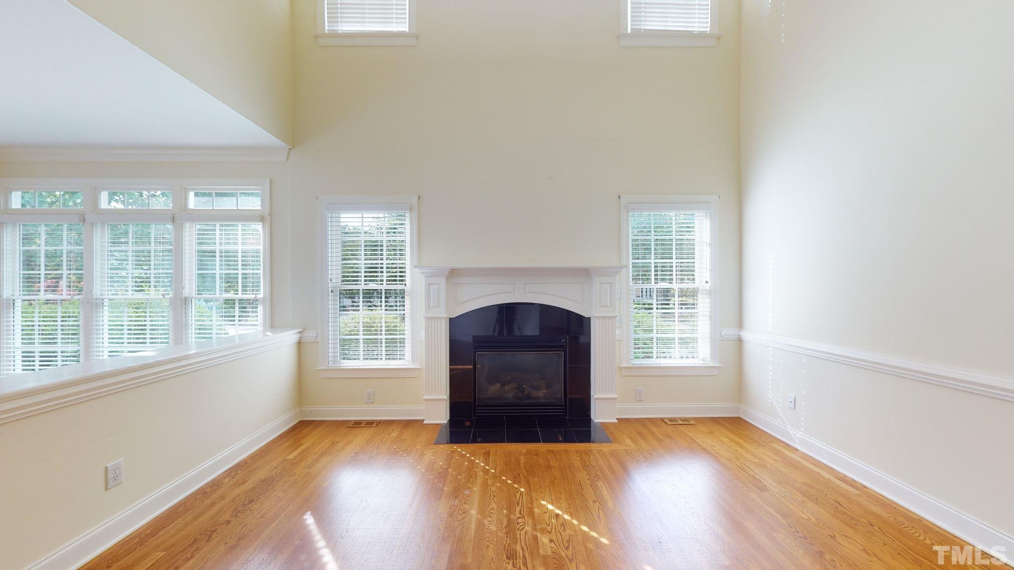 1931 Hornbeck Court Raleigh, NC 27614 - Photo 7 of 31 an empty room with wooden floor and windows
