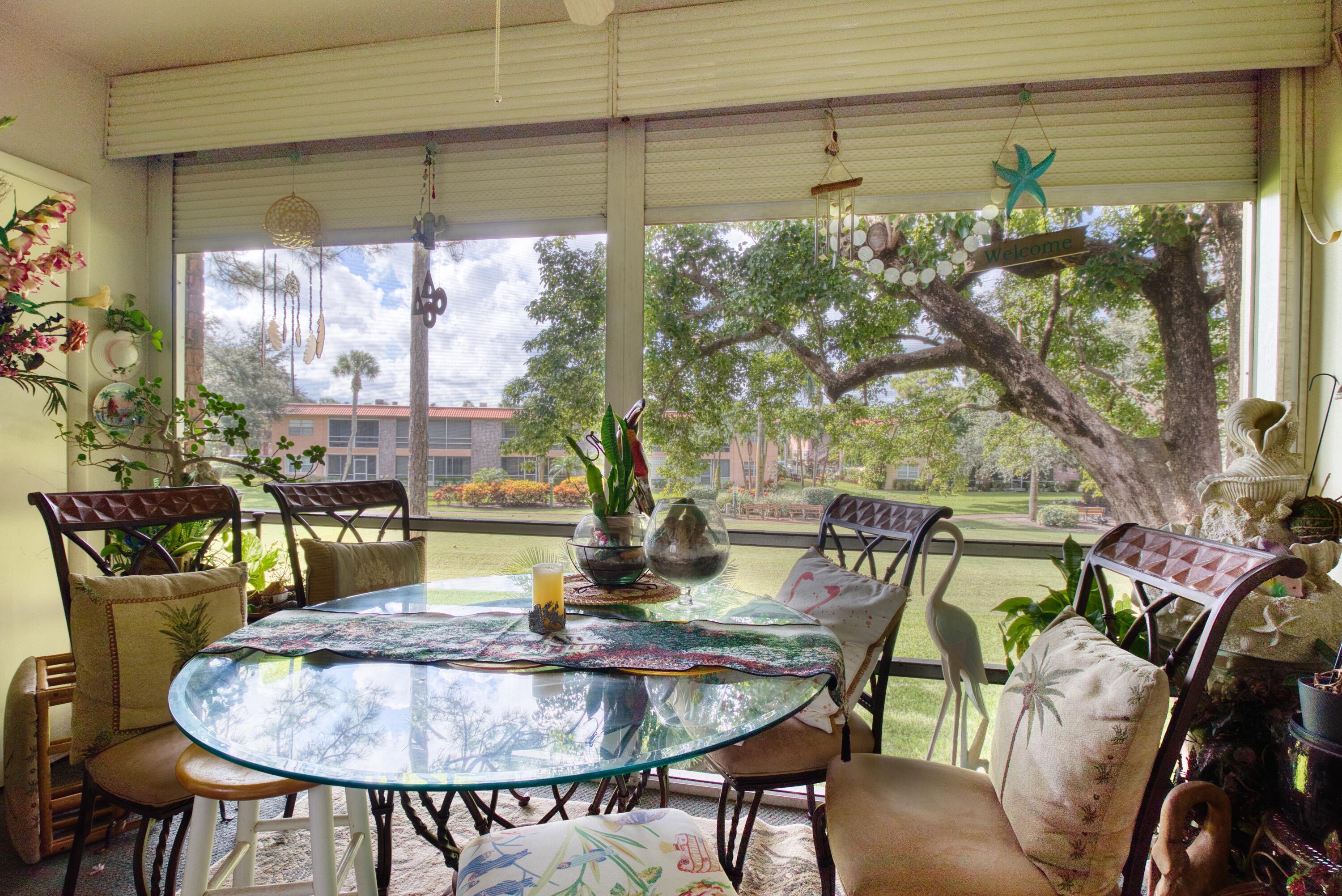 1911 Southwest Palm City Road, Unit J Stuart, FL 34994 - Photo 11 of 21 a view of a dining room with furniture window and outside view