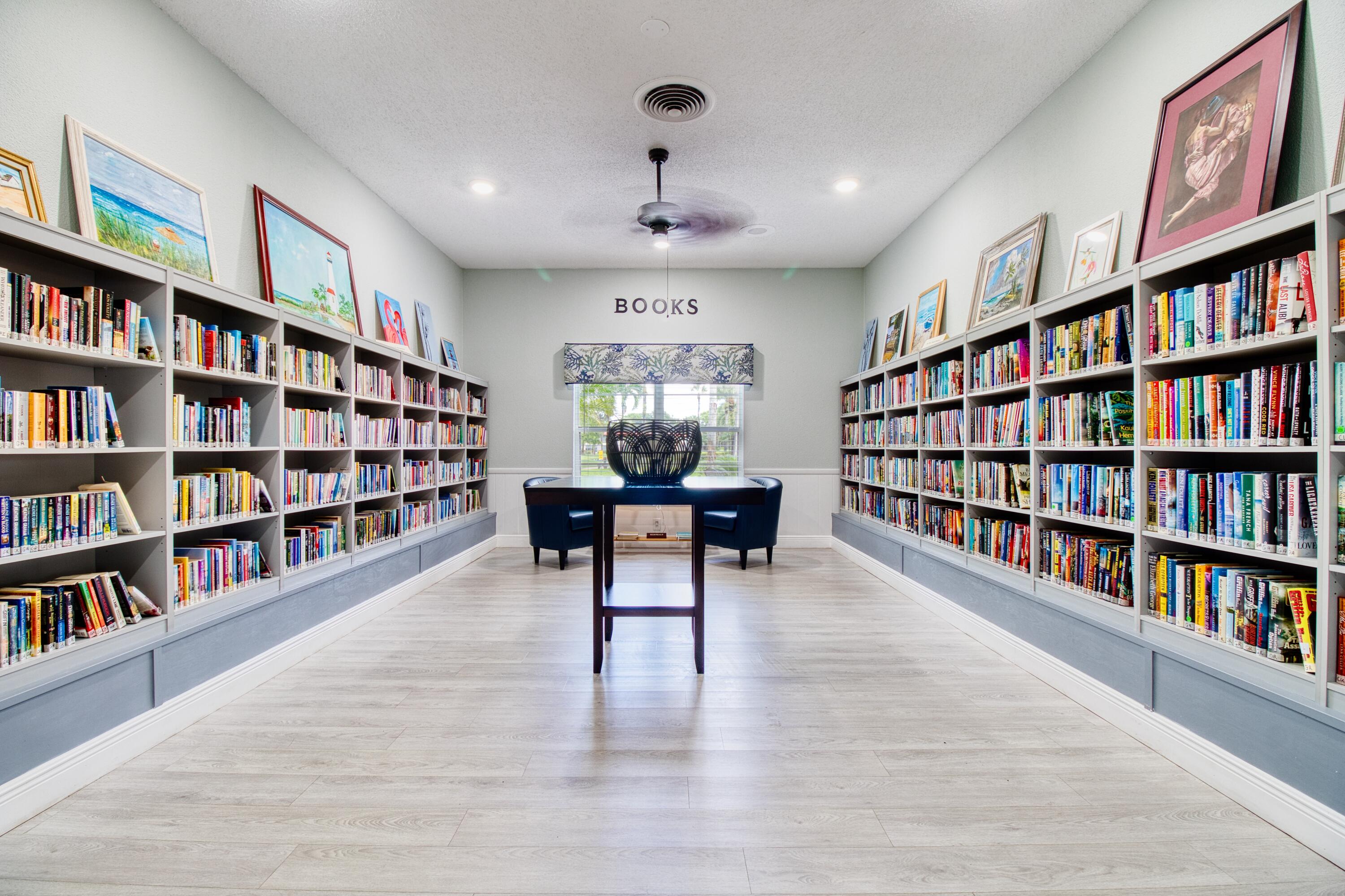 1911 Southwest Palm City Road, Unit J Stuart, FL 34994 - Photo 15 of 21 a living room with a book shelf and a book shelf