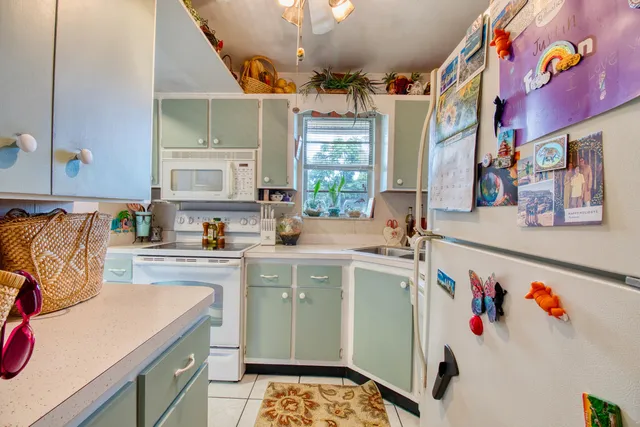 a kitchen that has a lot of cabinets a sink and a stove