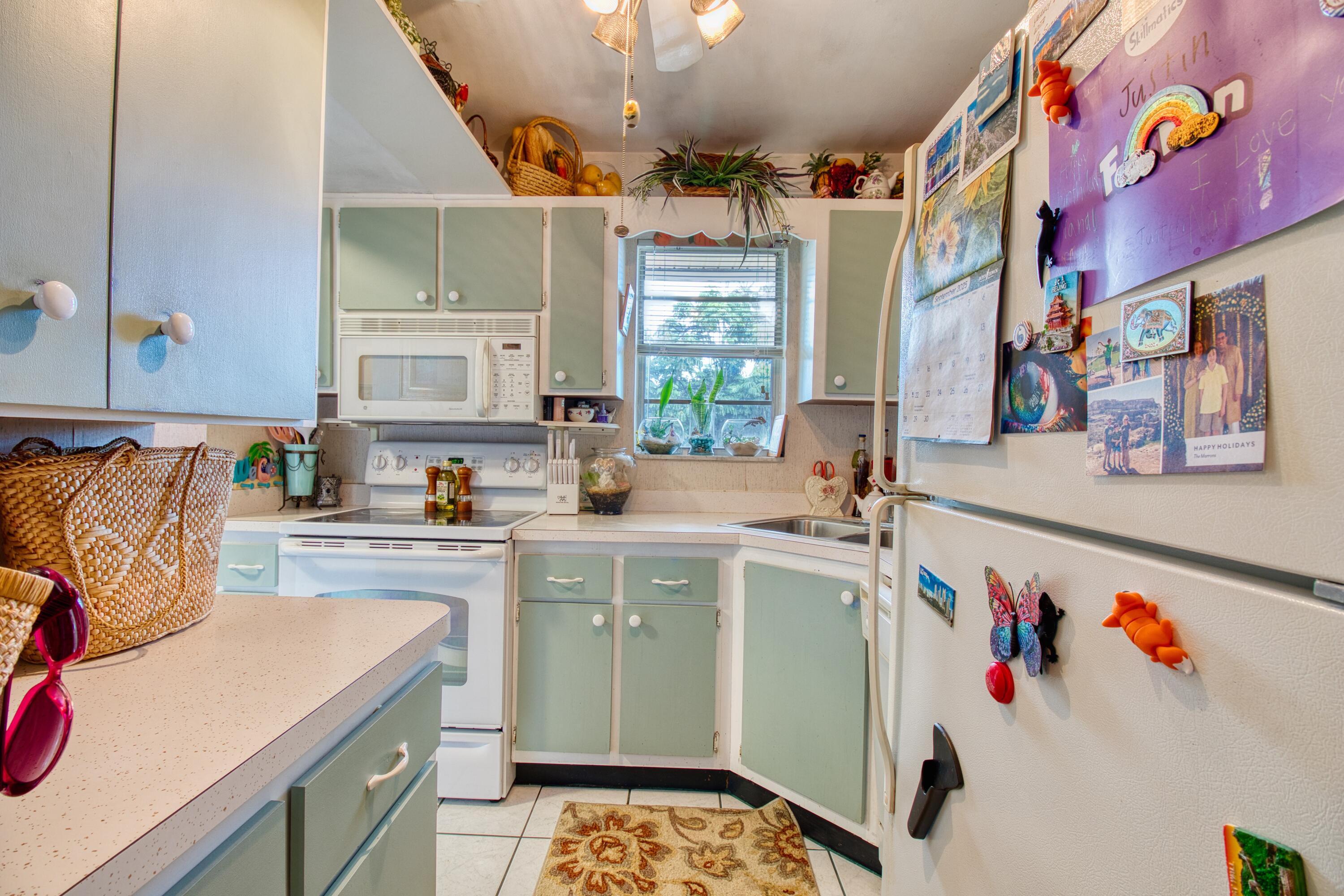 1911 Southwest Palm City Road, Unit J Stuart, FL 34994 - Photo 2 of 21 a kitchen that has a lot of cabinets a sink and a stove