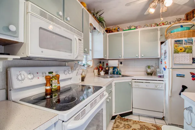 a kitchen with a sink cabinets and appliances