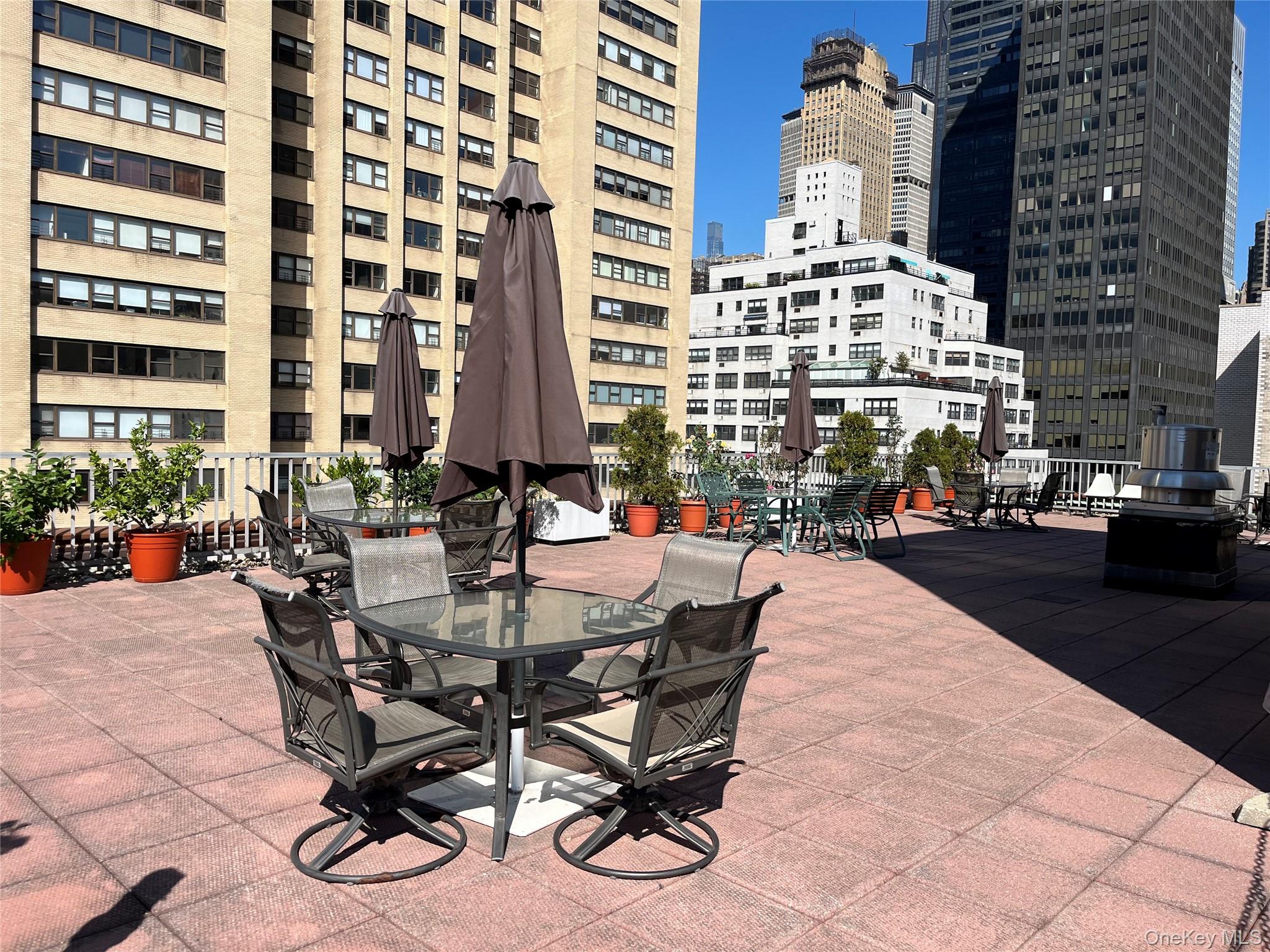 201 East 37th Street, Unit 7D Manhattan, NY 10016 - Photo 10 of 11 a view of a patio with dining table and chairs