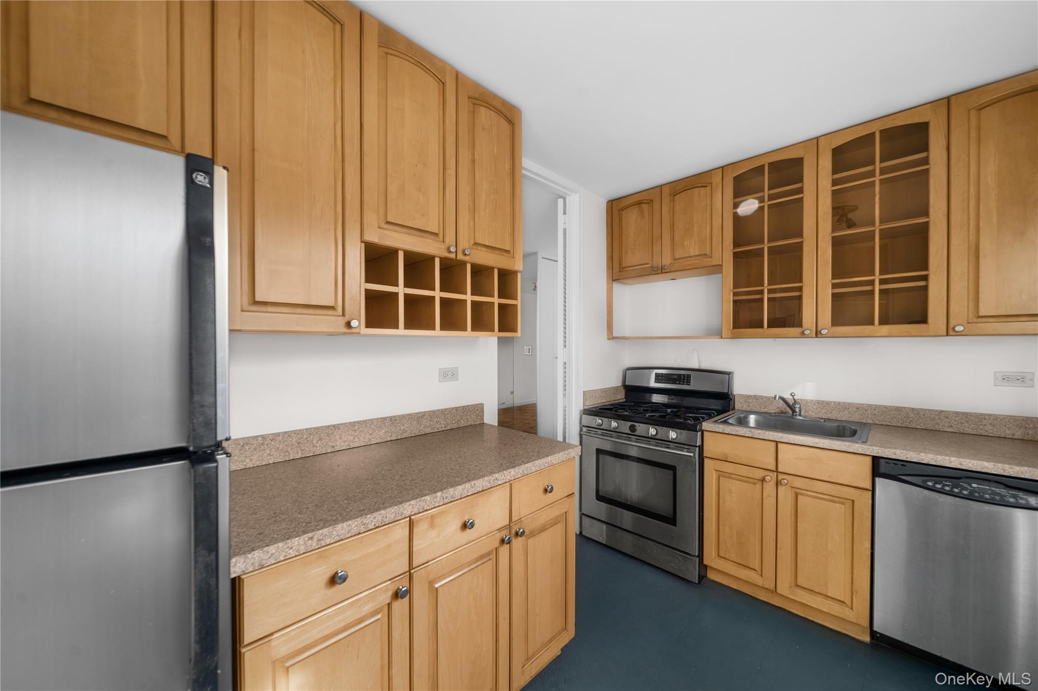 201 East 37th Street, Unit 7D Manhattan, NY 10016 - Photo 2 of 11 a kitchen with stainless steel appliances granite countertop a stove a sink and a refrigerator