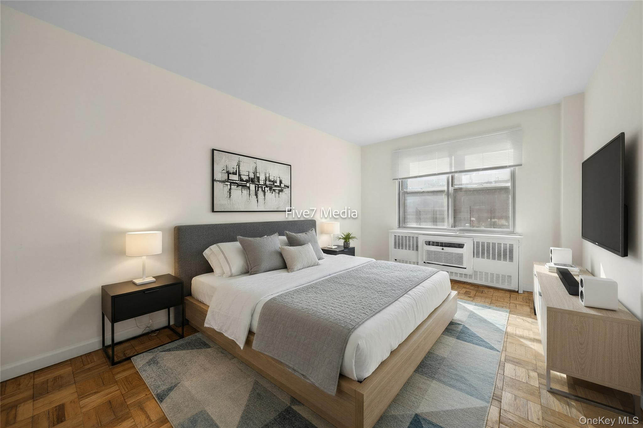 201 East 37th Street, Unit 7D Manhattan, NY 10016 - Photo 3 of 11 a bedroom with a bed and a flat screen tv