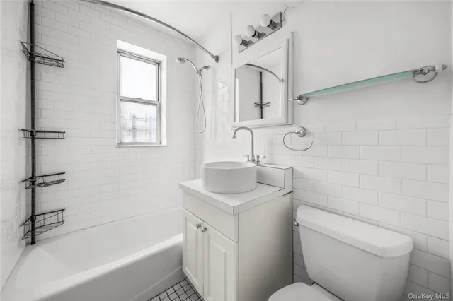 a bathroom with a sink toilet vanity and bathtub