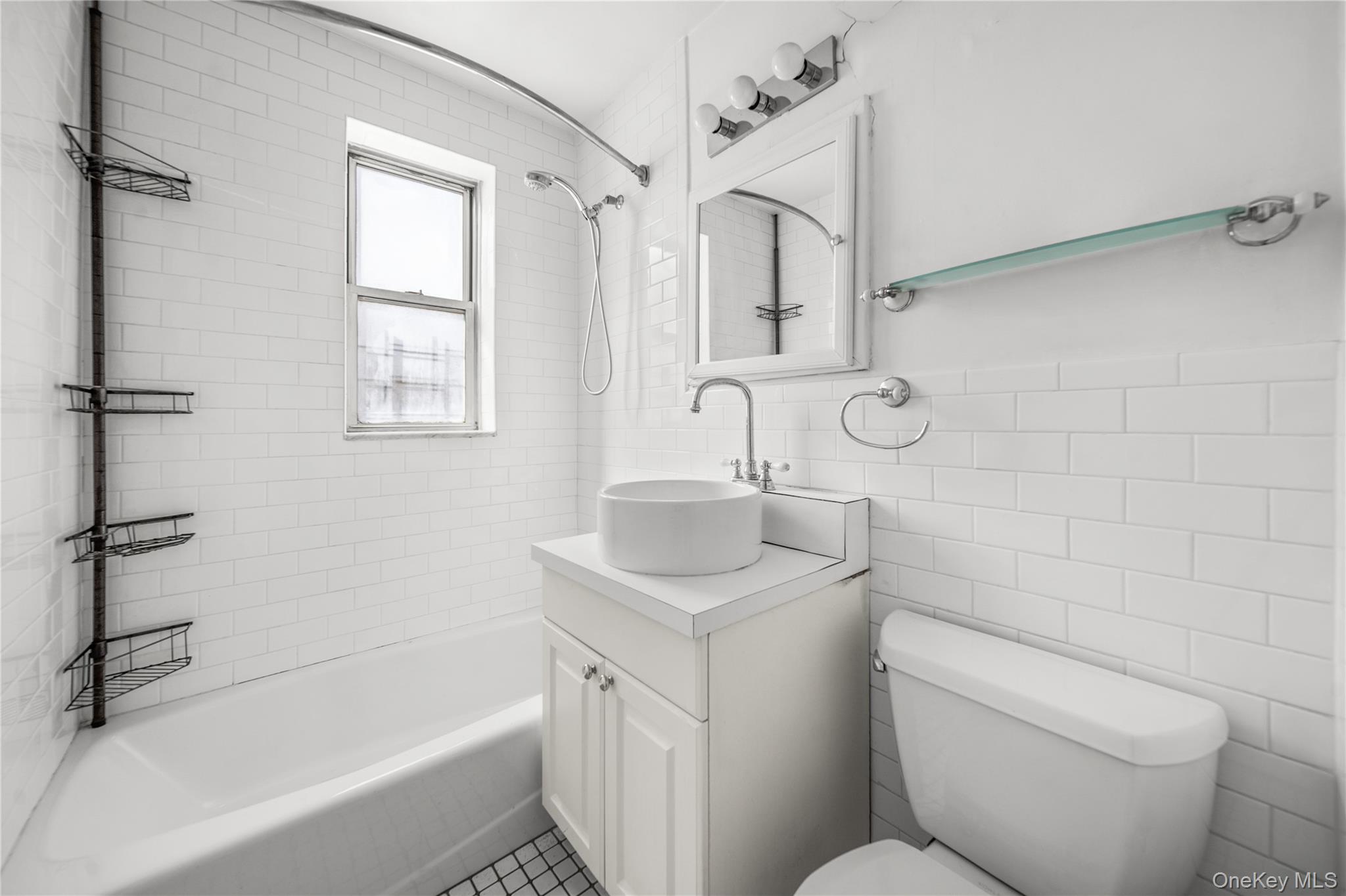 201 East 37th Street, Unit 7D Manhattan, NY 10016 - Photo 5 of 11 a bathroom with a sink toilet vanity and bathtub