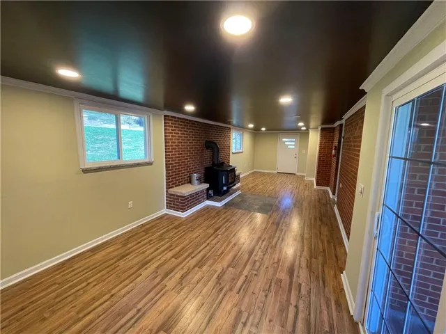a large white kitchen with a large window