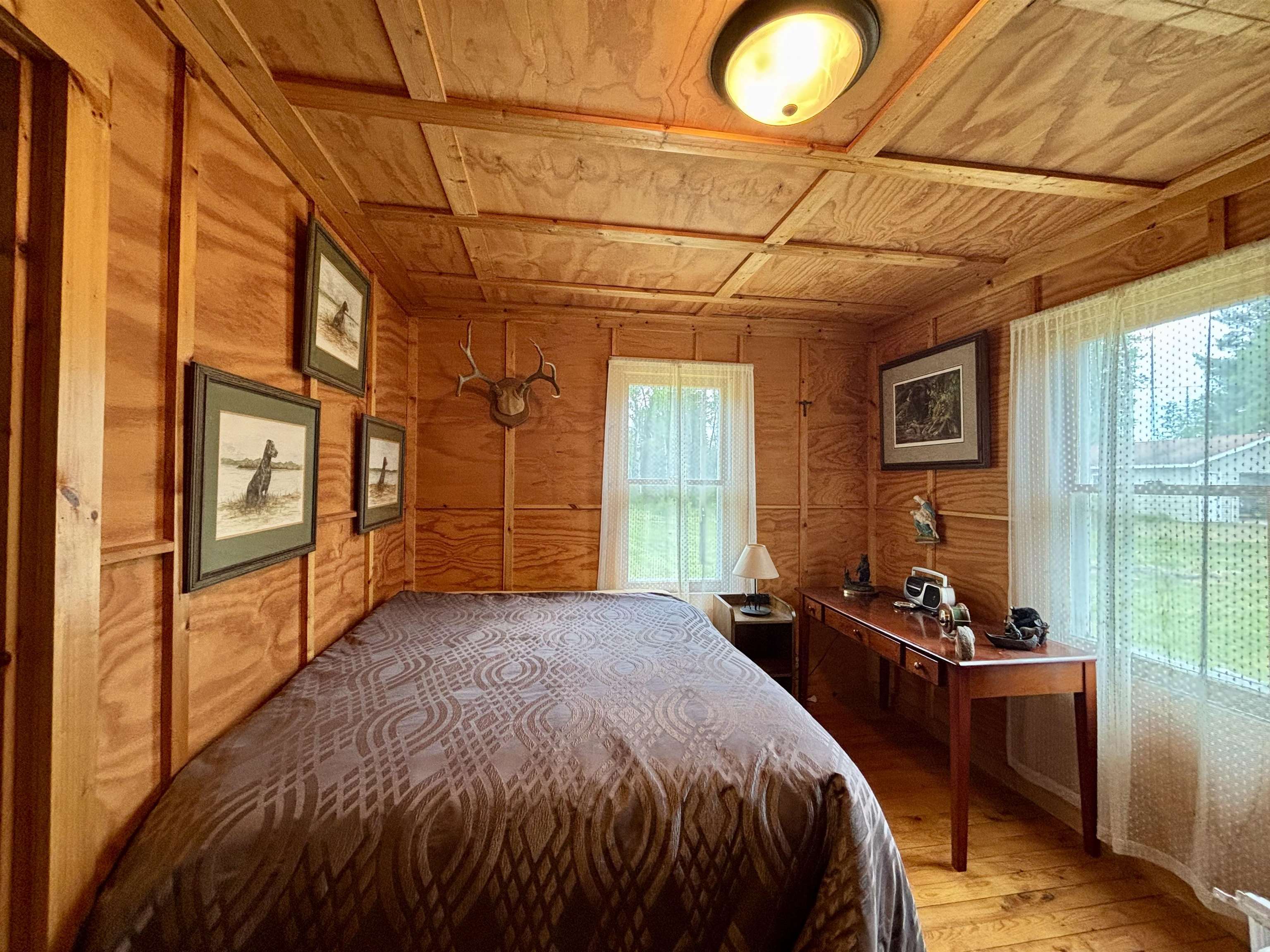 9724 State Highway 1 Isabella, MN 55607 - Photo 11 of 21 Bedroom with wooden walls, wood ceiling, and light wood-style flooring
