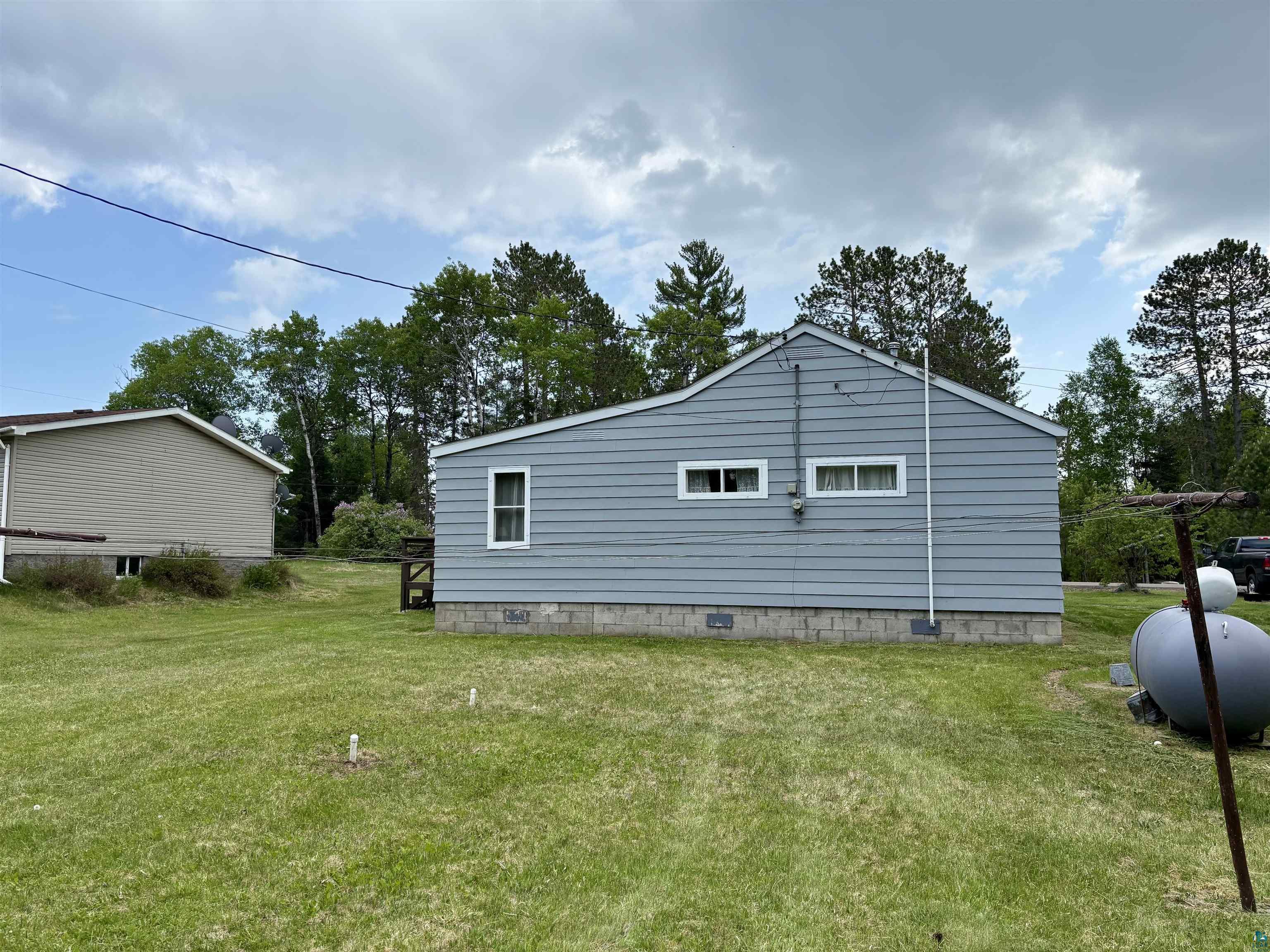 9724 State Highway 1 Isabella, MN 55607 - Photo 2 of 21 View of property exterior with a lawn and crawl space