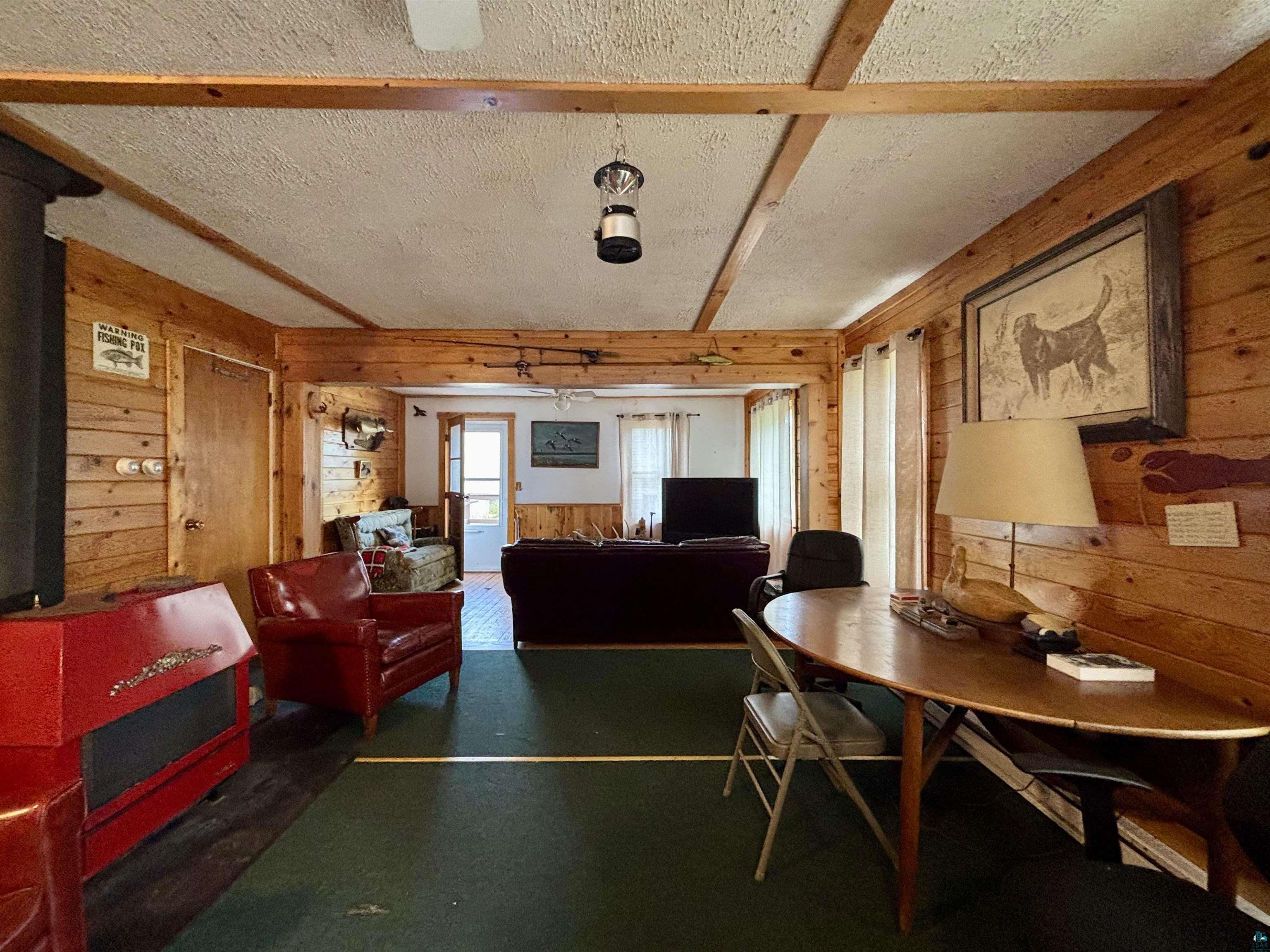 9724 State Highway 1 Isabella, MN 55607 - Photo 9 of 21 Dining space featuring wood walls and a textured ceiling