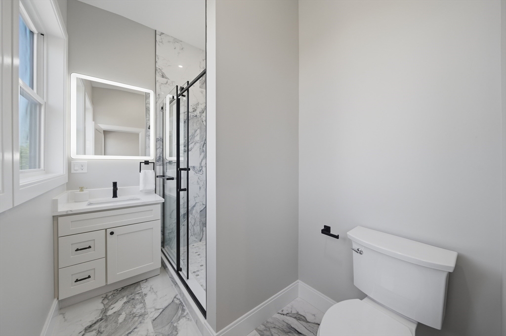 174 Walnut Street, Unit 3 Somerville, MA 02145 - Photo 10 of 38 a bathroom with a toilet a sink and mirror