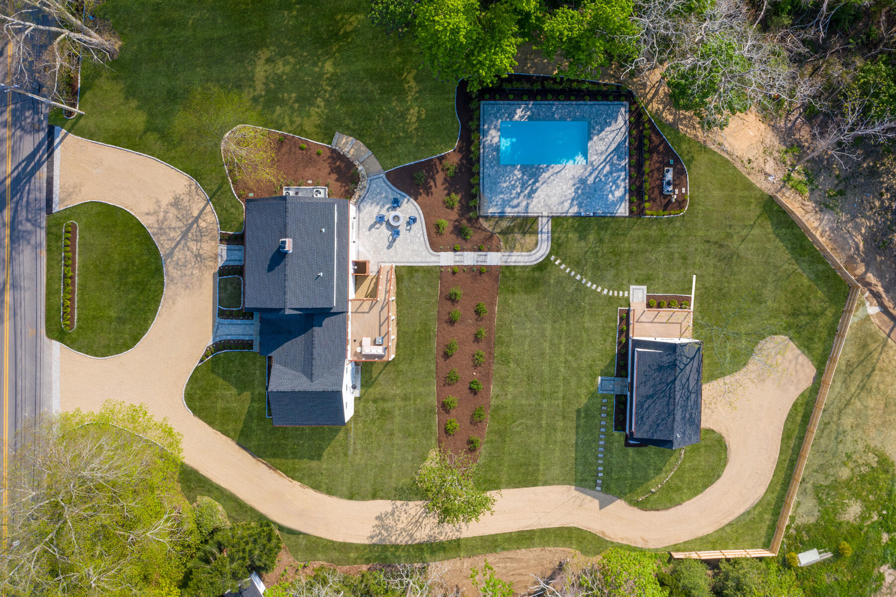 an aerial view of a house with outdoor space and a lake view