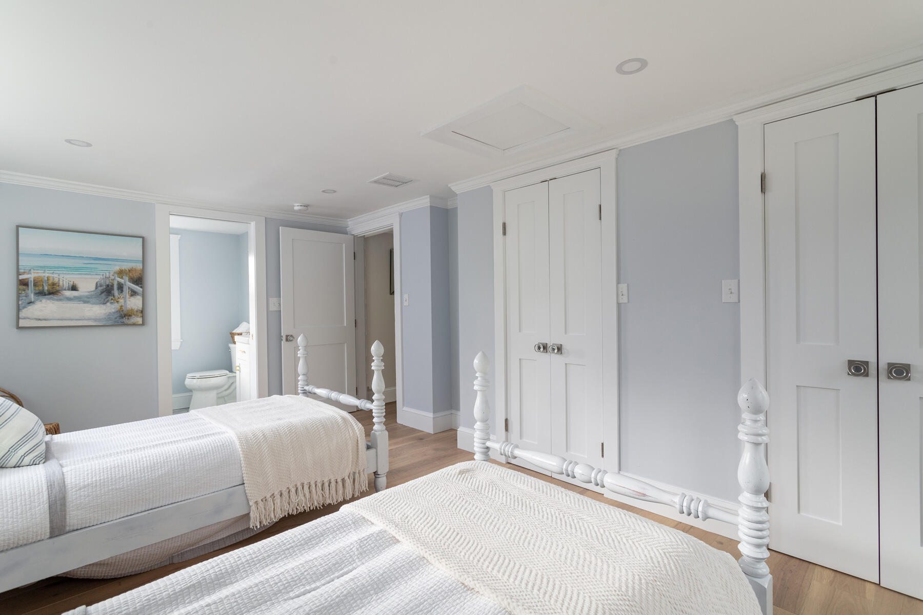 232 Tonset Road Orleans, MA 02653 - Photo 31 of 76 a bedroom with a large bed and a chandelier