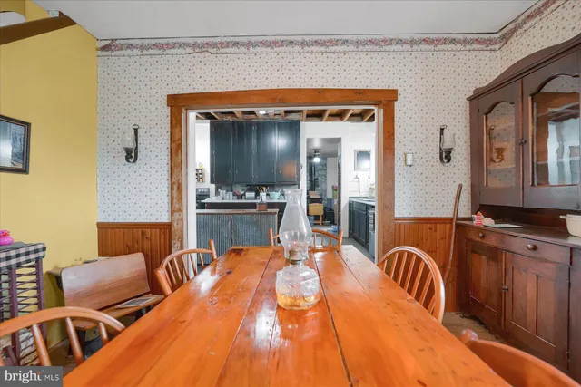 a dining room with furniture entryway and wooden floor